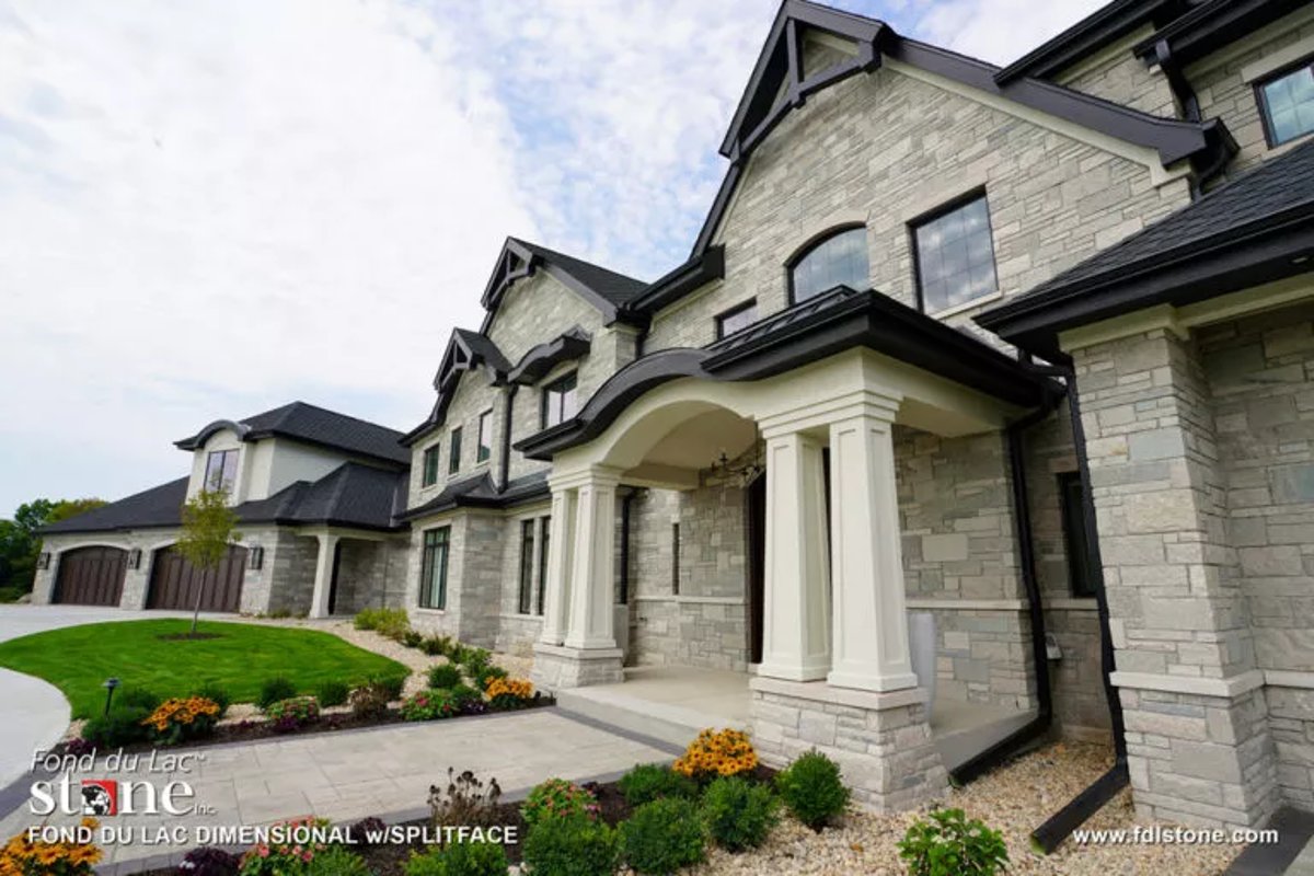 front view a luxurious house clad in stone veneer